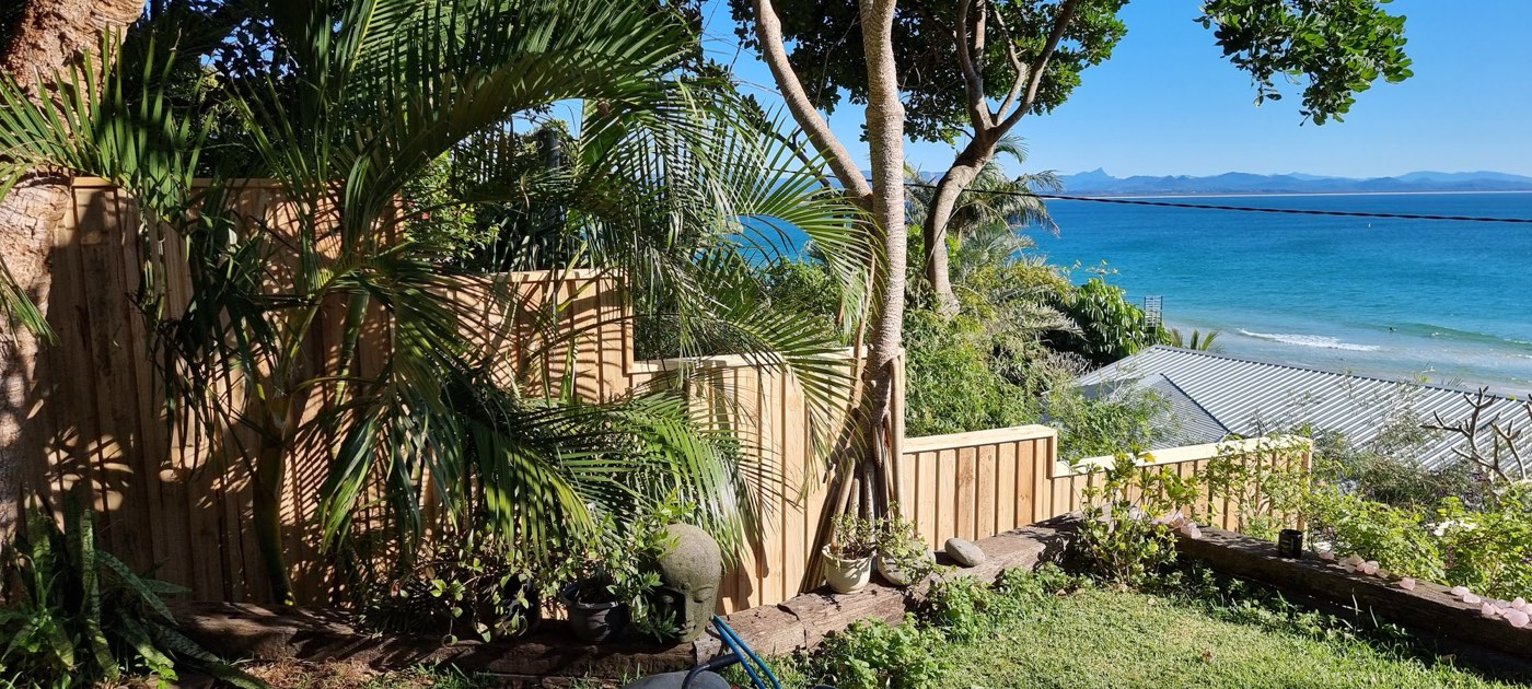 Stepped treated pine fence in a Byron Bay garden overlooking the ocean